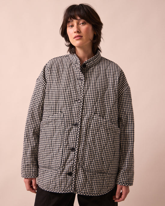 model wears rue black and white mini gingham denim jacket