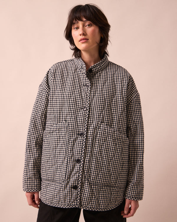 model wears rue black and white mini gingham denim jacket