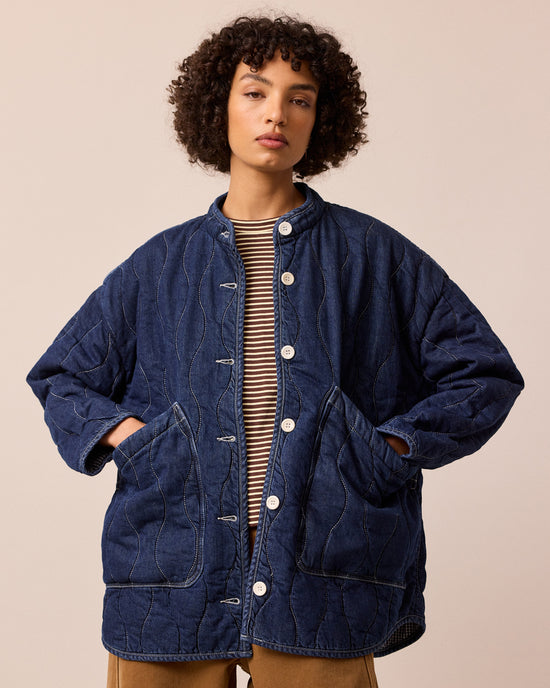 model wears rue mid blue denim quilted jacket