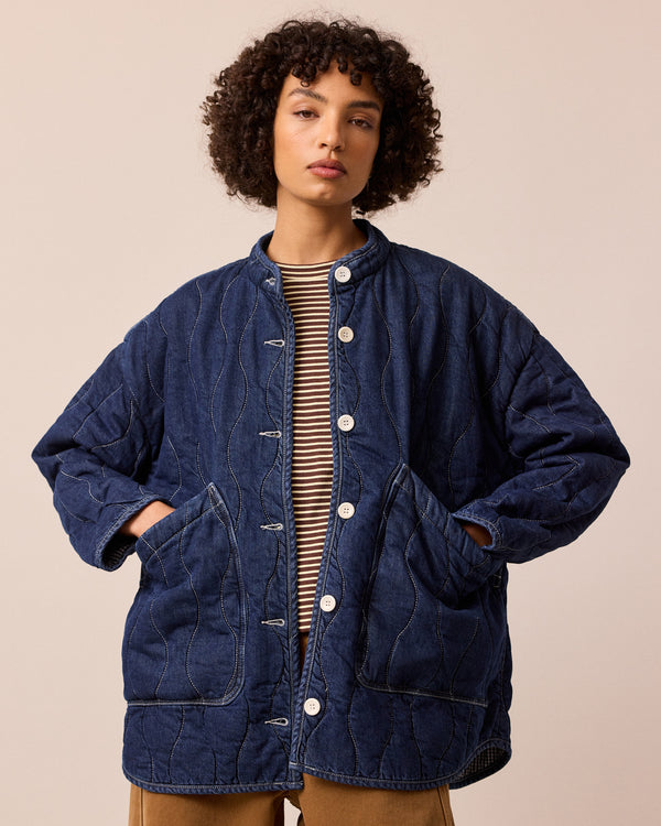 model wears rue mid blue denim quilted jacket