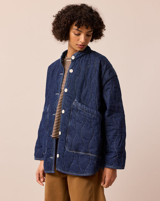 model wears rue mid blue denim quilted jacket