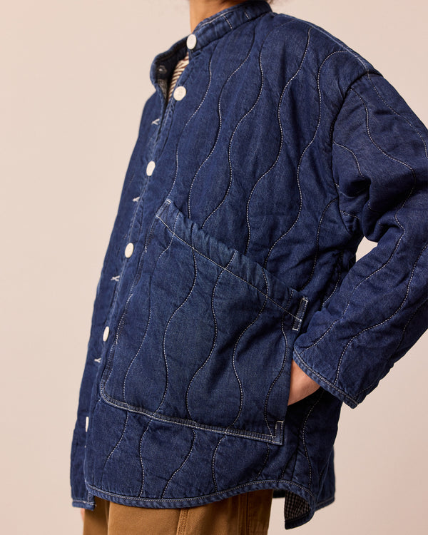 model wears rue mid blue denim quilted jacket