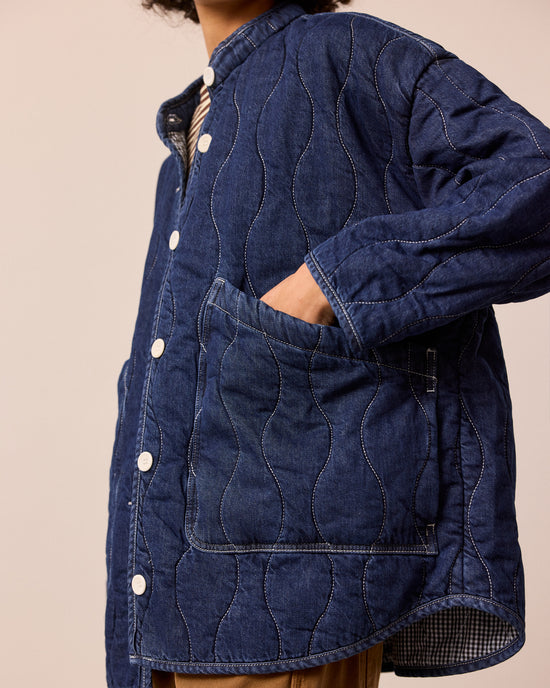 model wears rue mid blue denim quilted jacket