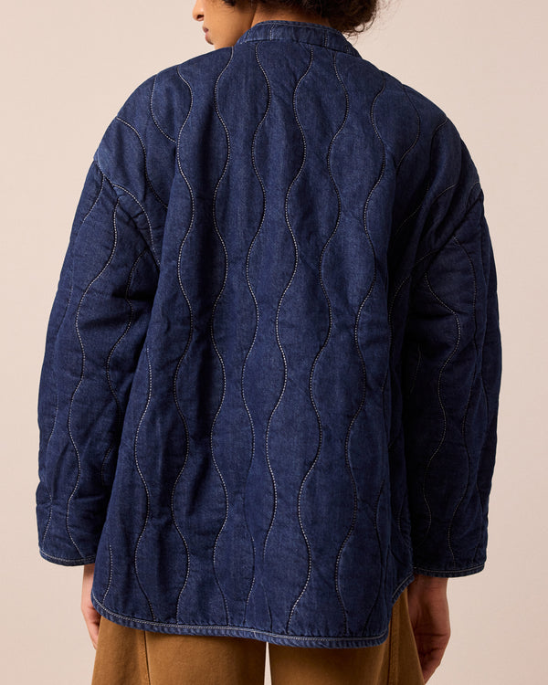 model wears rue mid blue denim quilted jacket