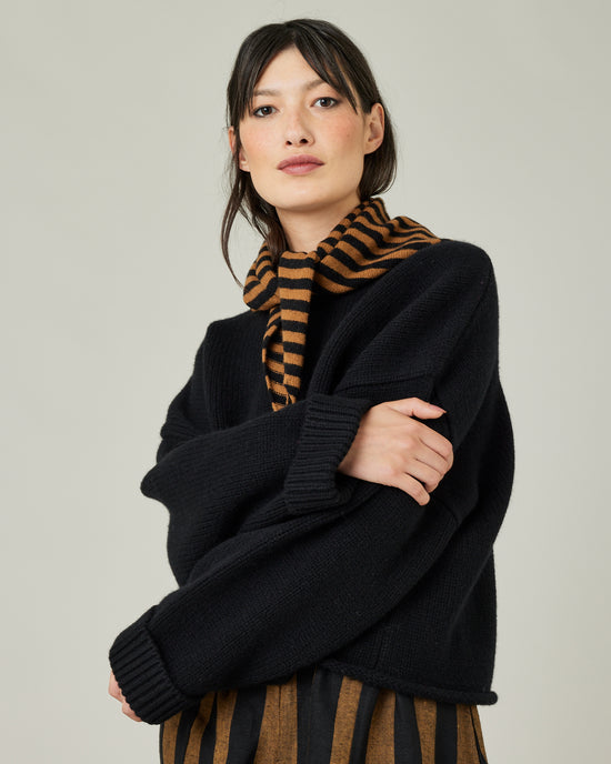 model wears knitted rust stripe neckerchief