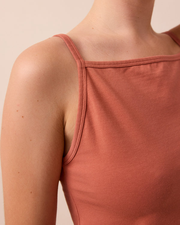 model wears terracotta vest