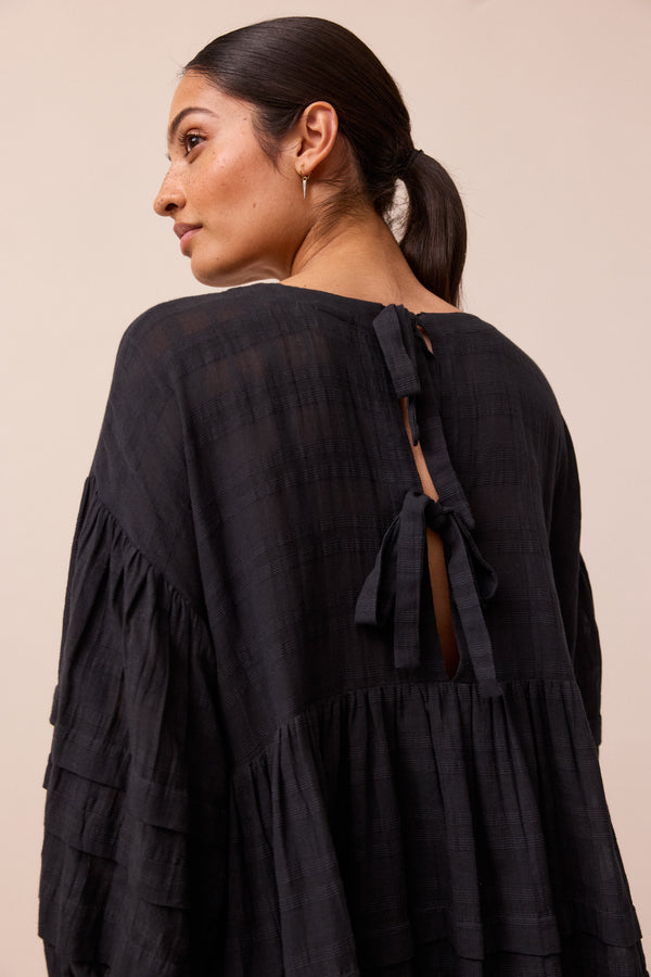 model wears black nina smock dress 