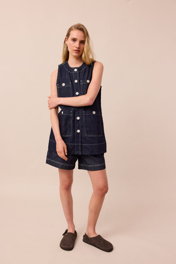 model wears indigo rinse wash denim shorts