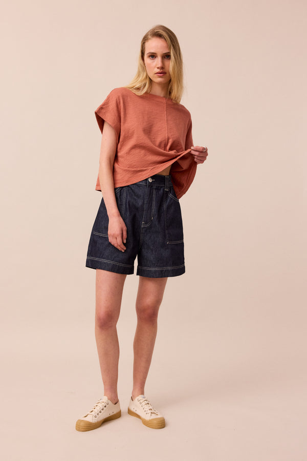 model wears indigo rinse wash denim shorts