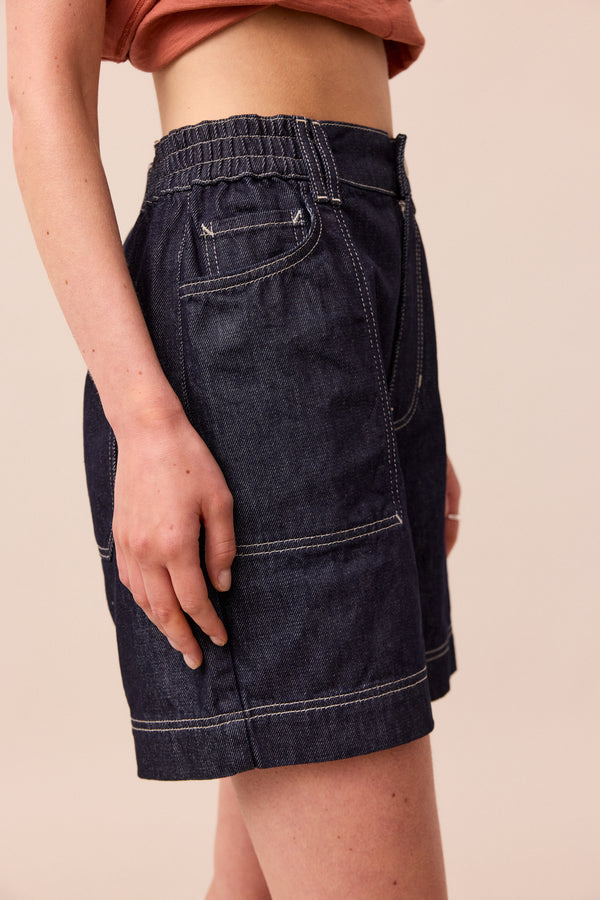 model wears indigo rinse wash denim shorts
