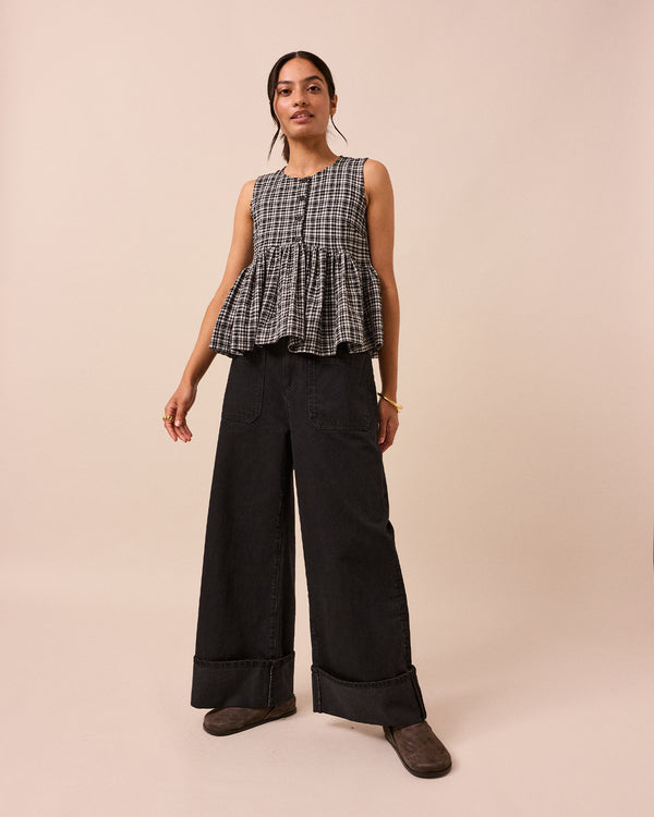 model wears black and white gingham anais seersucker top