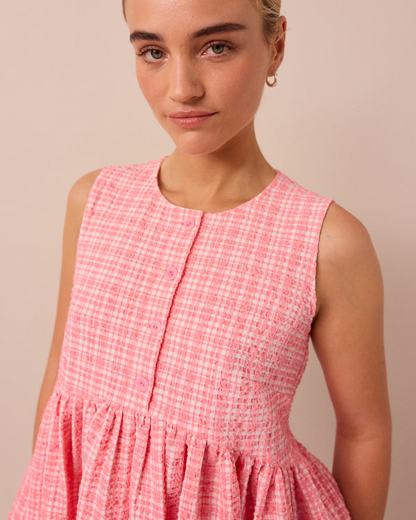 model wears pink gingham anais seersucker top