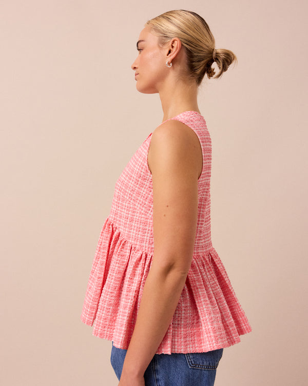 model wears pink gingham anais seersucker top