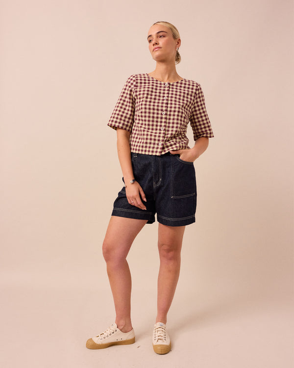 model wears evelyn butter and burgundy cotton linen top
