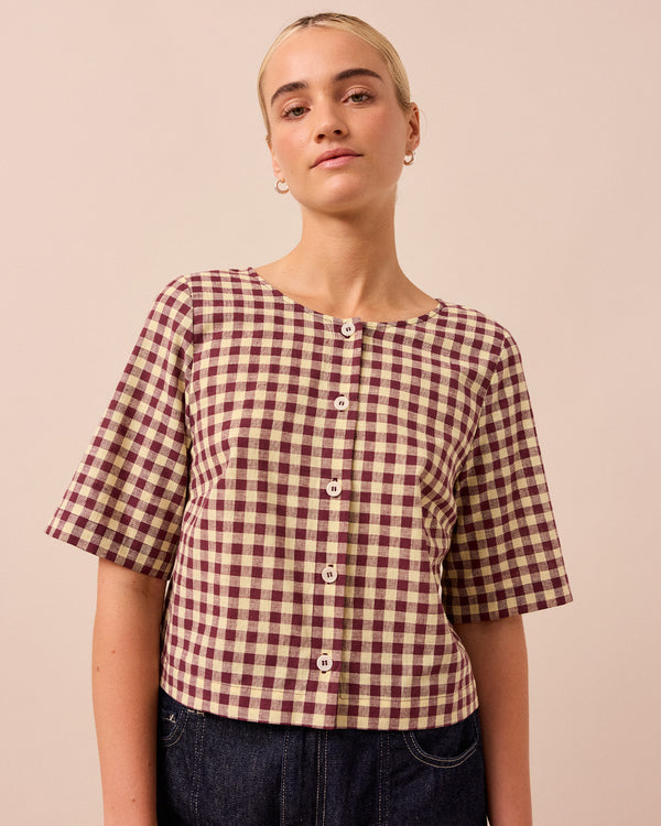 model wears evelyn butter and burgundy cotton linen top
