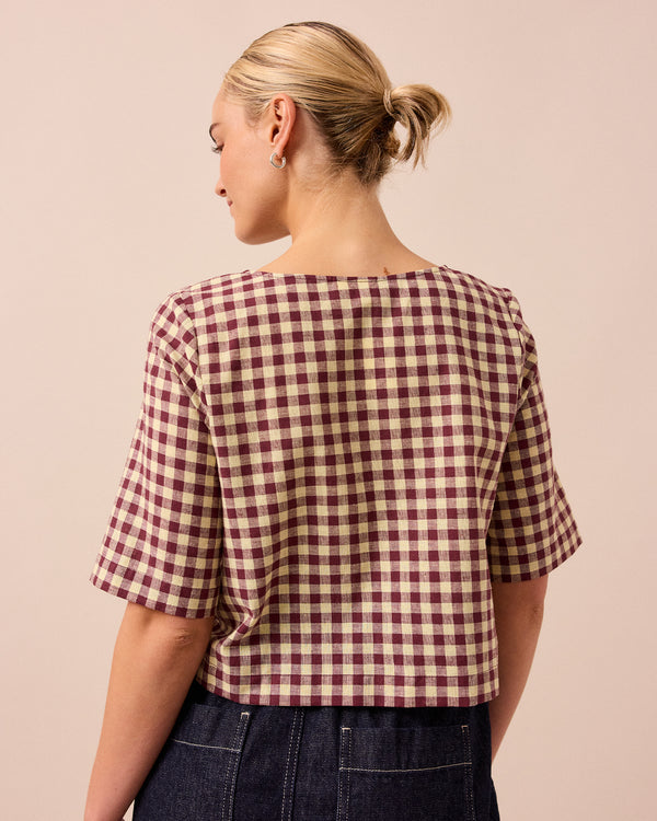 model wears evelyn butter and burgundy cotton linen top