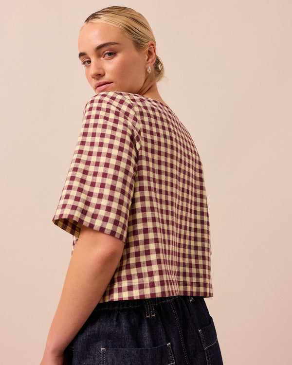 model wears evelyn butter and burgundy cotton linen top