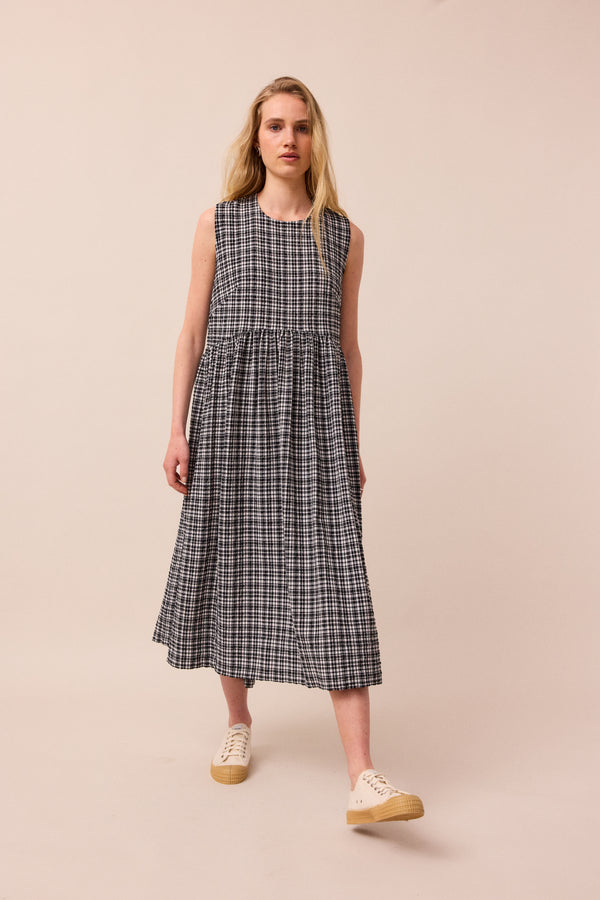 model wears black and white gingham darcy dress