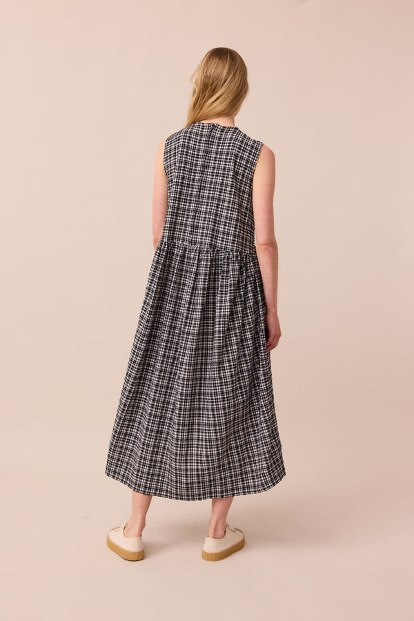 model wears black and white gingham darcy dress