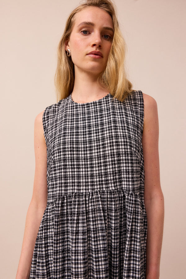 model wears black and white gingham darcy dress