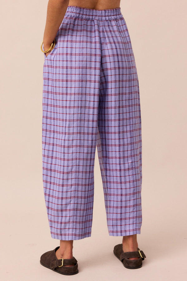 model wears parma violet mabel linen trousers left