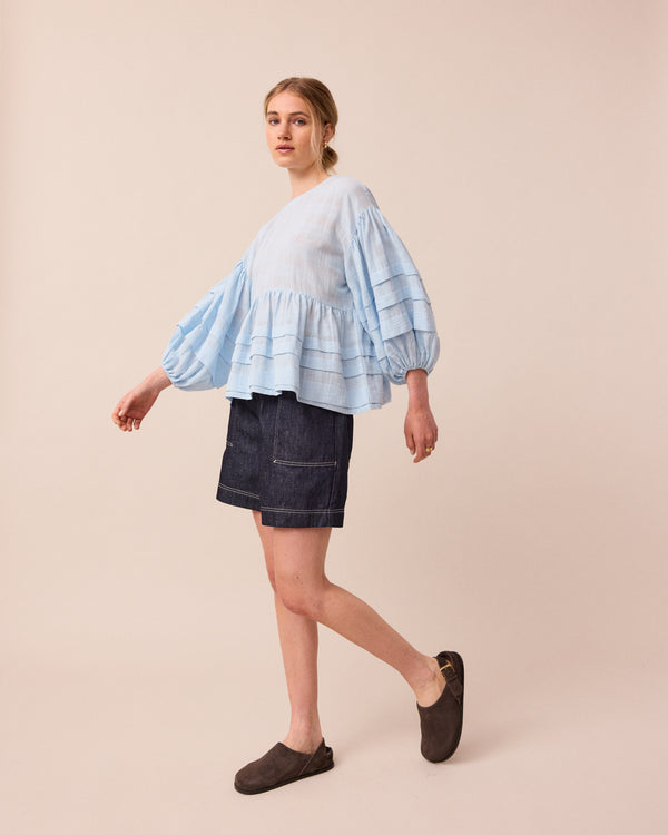 model wears sky blue simone top