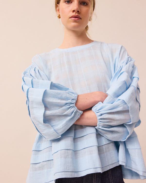 model wears sky blue simone top