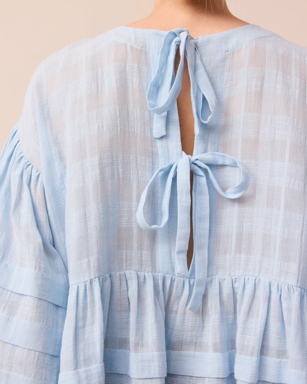 model wears sky blue simone top