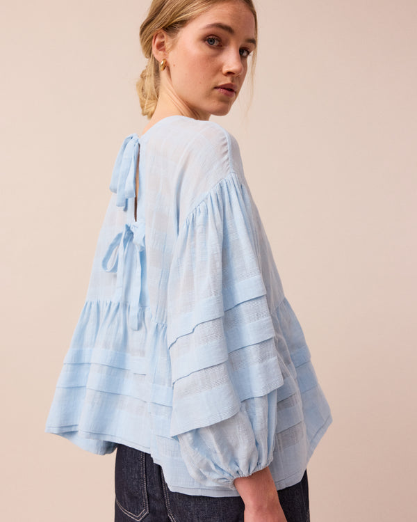 model wears sky blue simone top