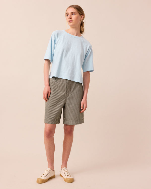 model wears sky blue raglan tee