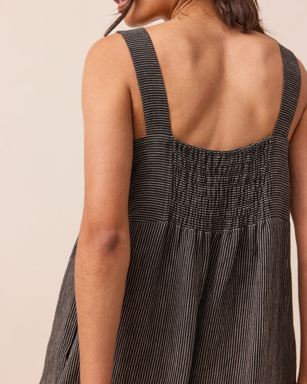 model wears black and ecru pencil stripe cari linen jumpsuit