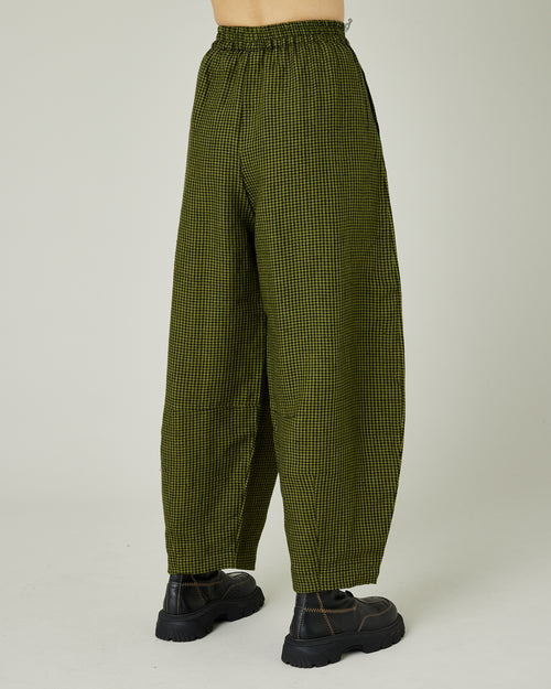 model wears olive and black micro check daisy trousers right