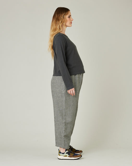 pregnant model wears black and stone micro check linen mabel trousers