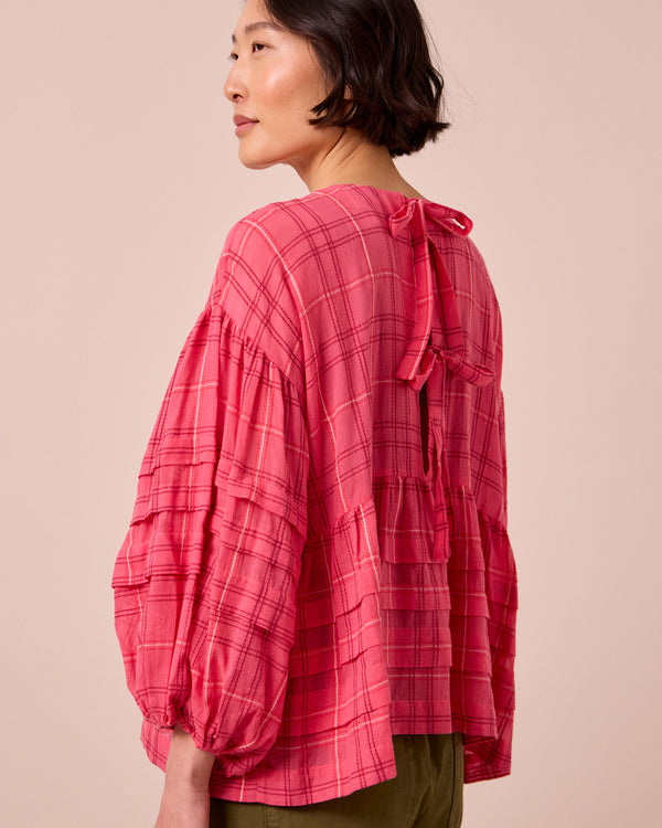 model wears simone hot pink cotton gauze top