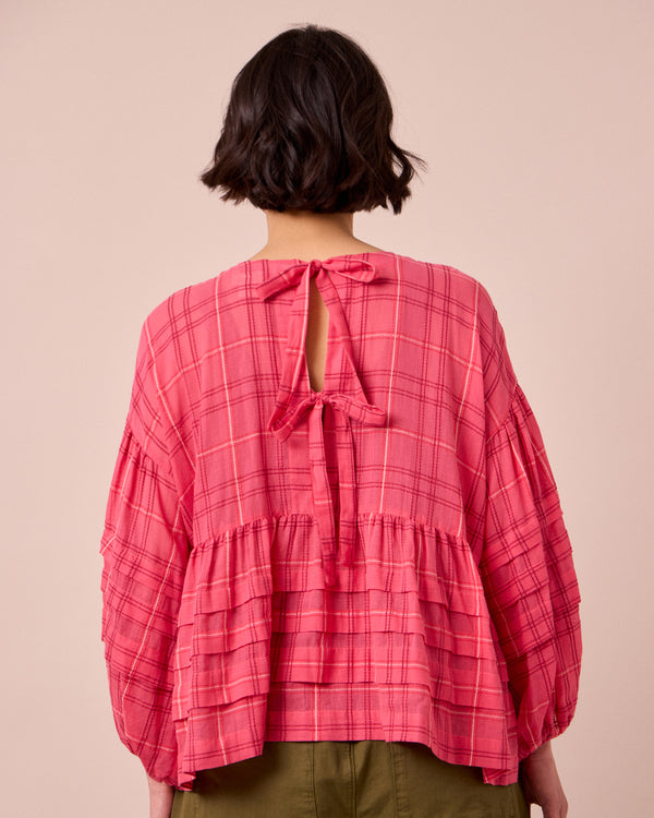 model wears simone hot pink cotton gauze top