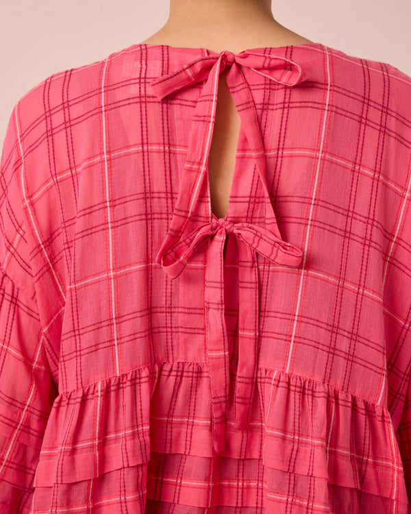 model wears simone hot pink cotton gauze top
