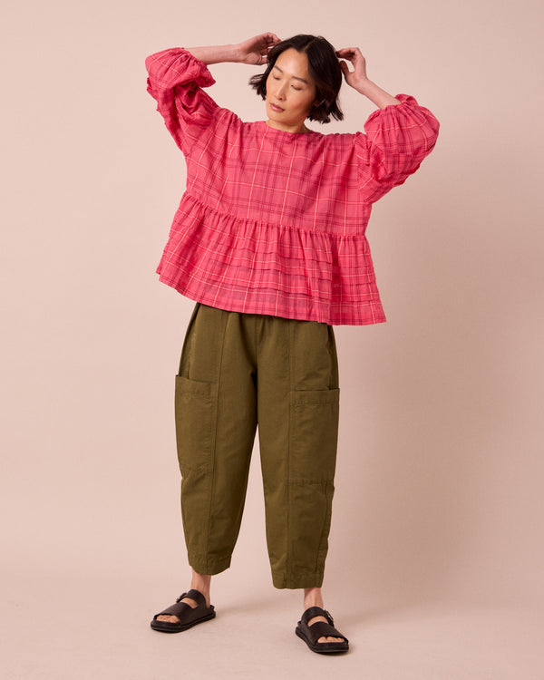 model wears simone hot pink cotton gauze top