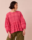 model wears simone hot pink cotton gauze top