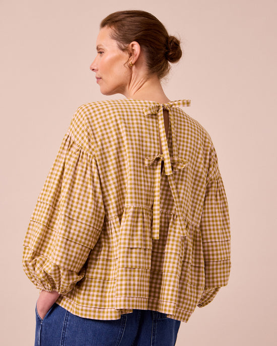 model wears simone garden gingham cotton linen top