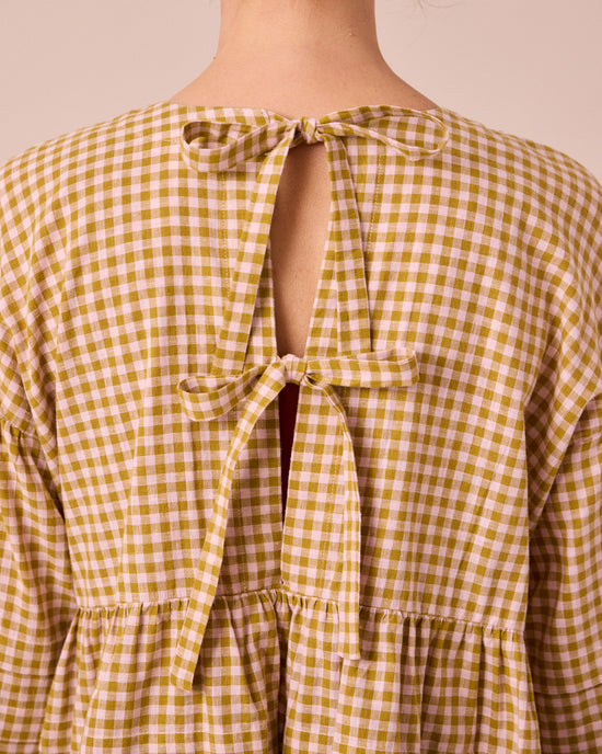 model wears simone garden gingham cotton linen top