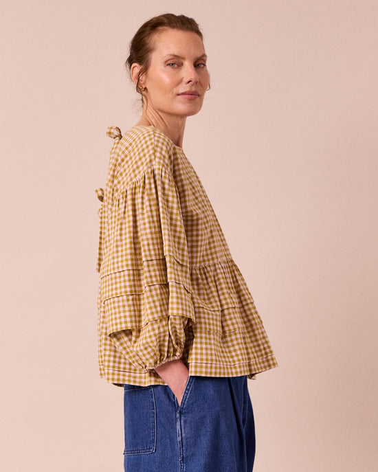 model wears simone garden gingham cotton linen top