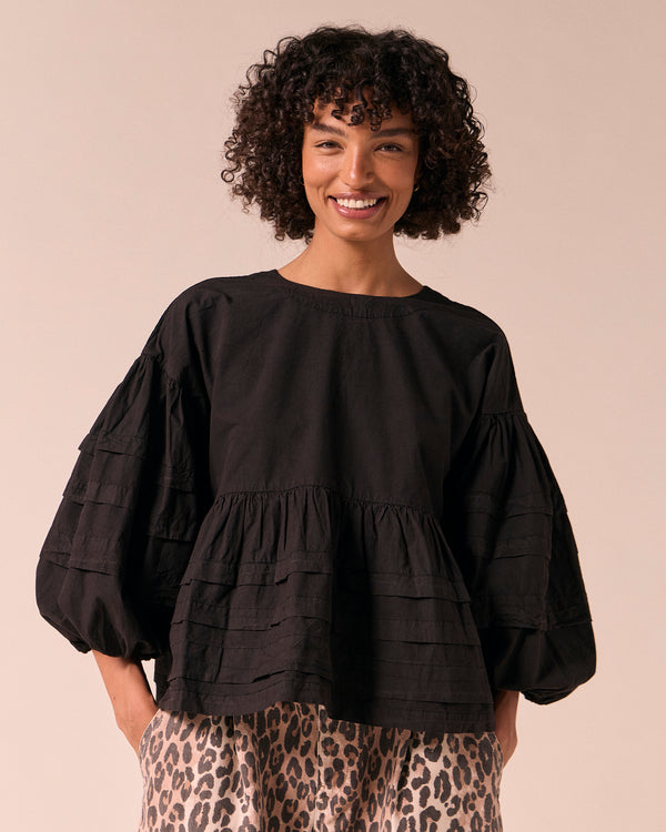model wears simone black cotton smock top