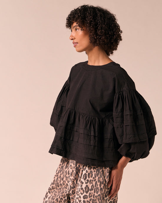 model wears simone black cotton smock top