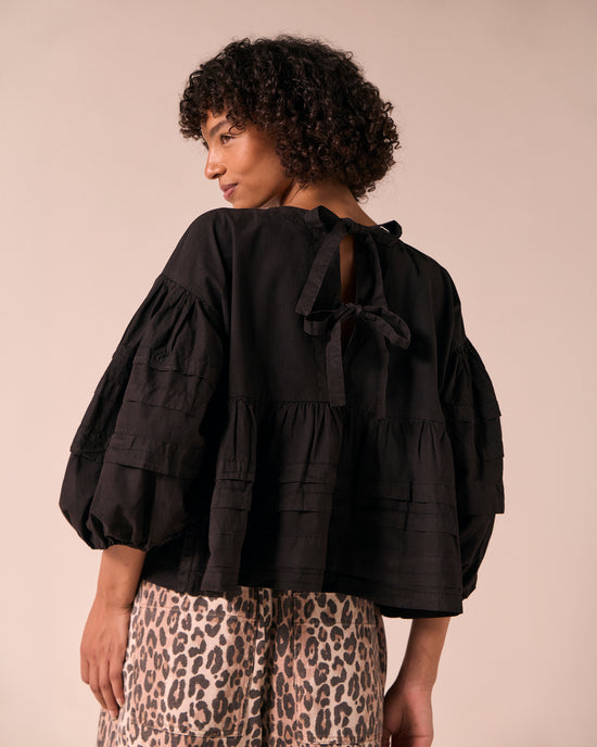 model wears simone black cotton smock top