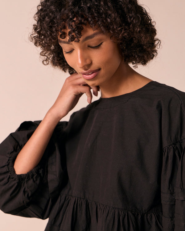 model wears simone black cotton smock top