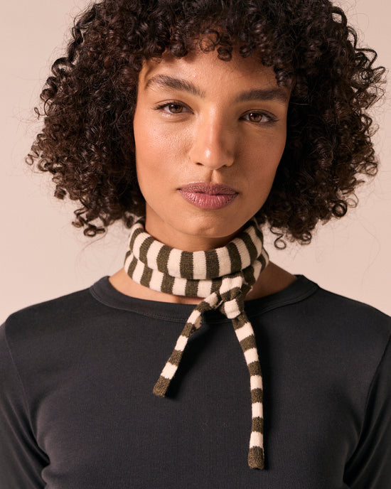model wears skinny olive and bone knitted neckerchief