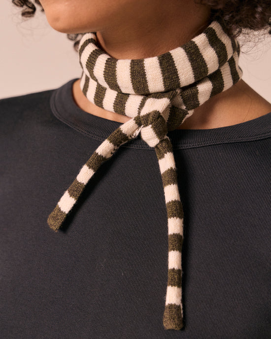model wears skinny olive and bone knitted neckerchief