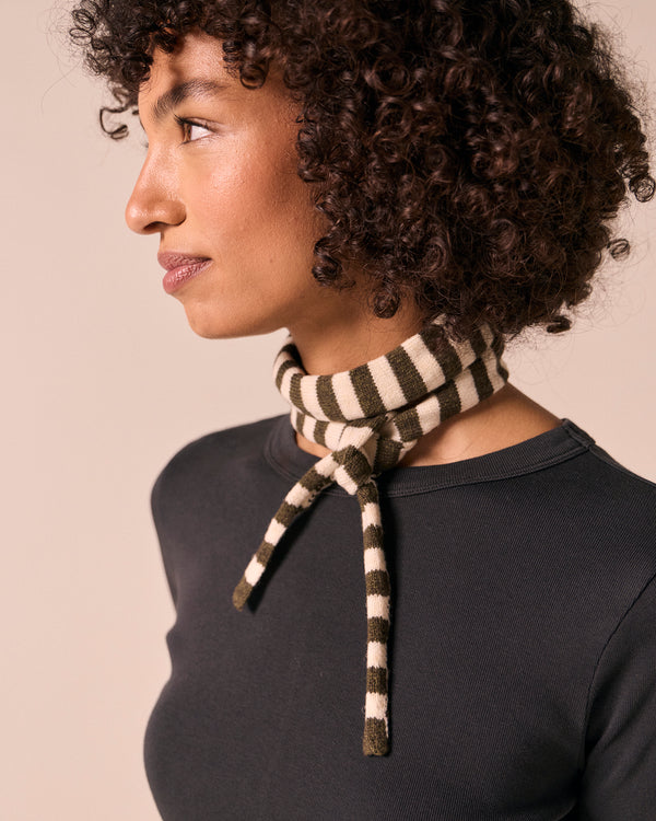model wears skinny olive and bone knitted neckerchief