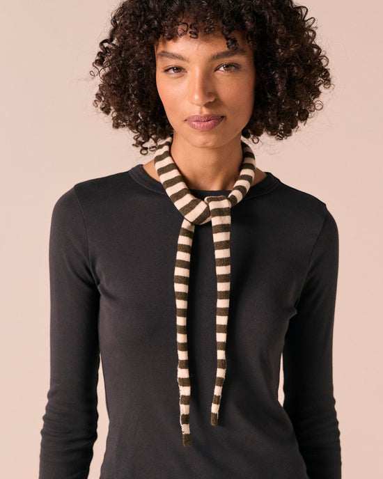 model wears skinny olive and bone knitted neckerchief