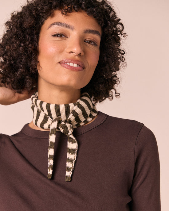 model wears olive and bone knitted skinny neckerchief